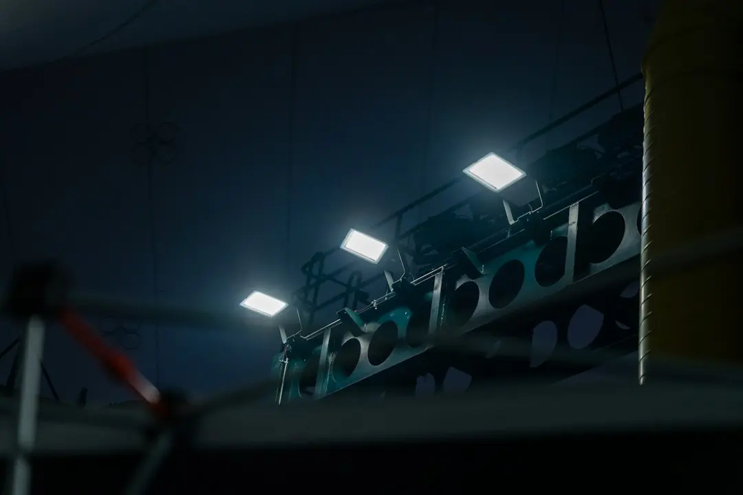 Floodlights above the ropes of a boxing ring in a dark arena, the kind of pay-per-view night Drogon TV includes